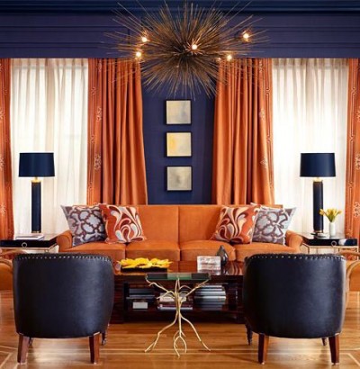 Orange curtains and upholstery against dark grey walls is an excellent pairing that reads both masculine and elegant