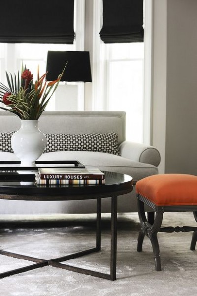 A pop of orange in this chic dove grey neutral room does the trick perfectly