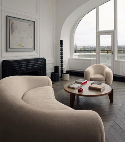 This curved sofa works beautifully in this minimalist room. Curved sofas are perfect to use when your room has too many rectangles. In this case, it is a story in roundness.