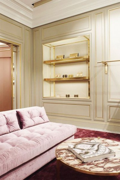 Blush pink sofa with a rich jewel tone carpet, creamy pale celadon walls and gold trim. A very sophisticated palette in the Pucci Flagship on Madison Avenue in New York